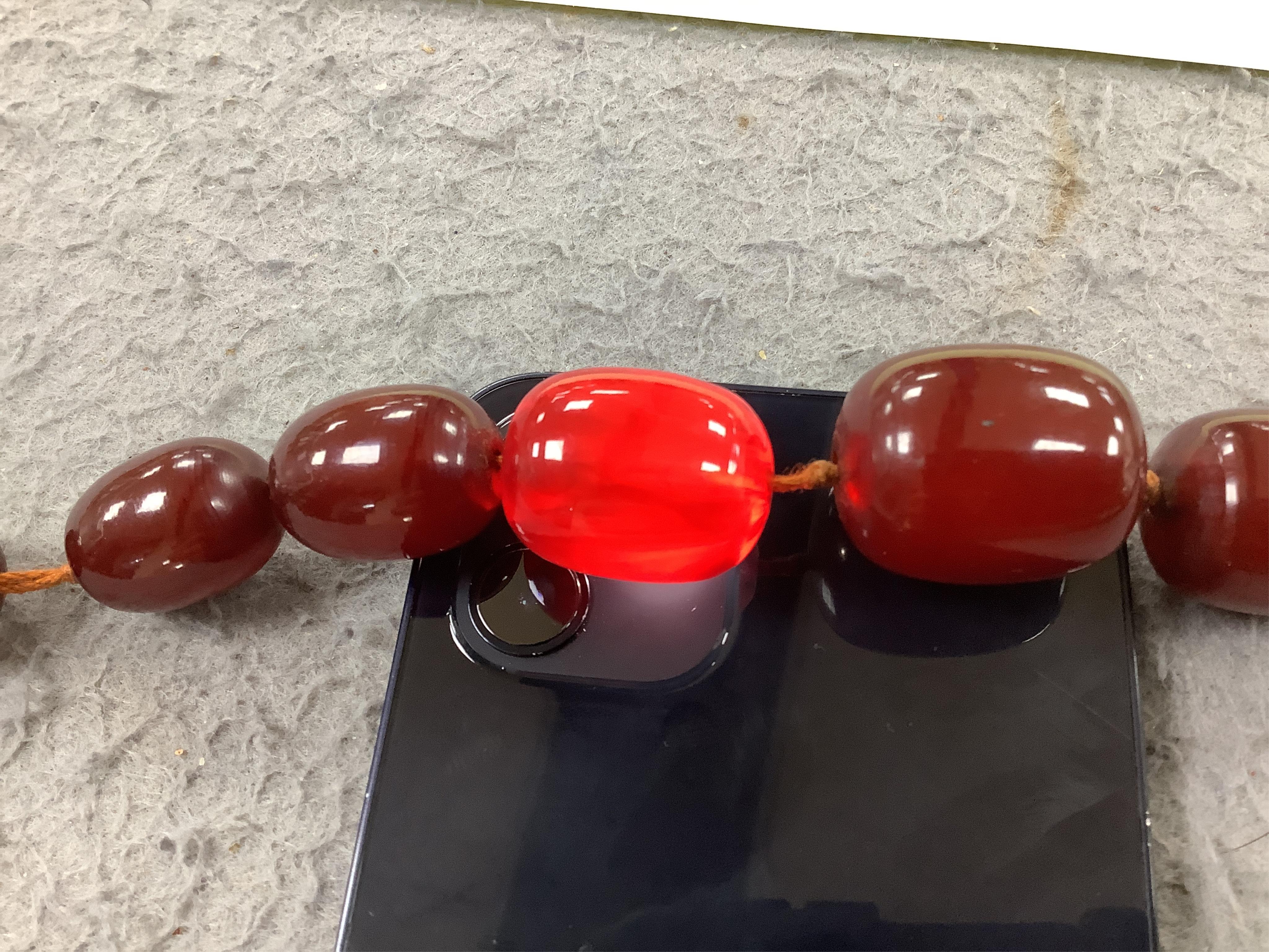 A single strand graduated simulated cherry amber necklace, 68cm gross weight 108 grams, Condition - fair